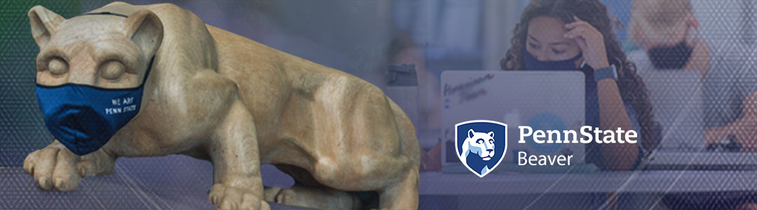 Penn State Beaver. Penn State Nittany Lion Shrine wearing protective mask. Masked Students in campus computer lab in background. 
