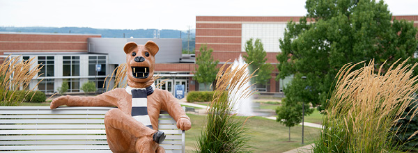 Nittany Lion statue sitting on a bench at Penn State Fayette