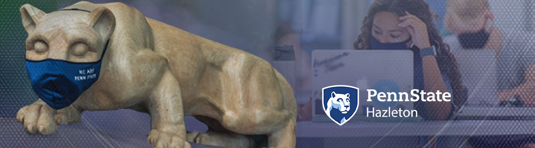 Penn State Abington. Penn State Nittany Lion Shrine wearing protective mask. Masked Students in campus computer lab in background. 